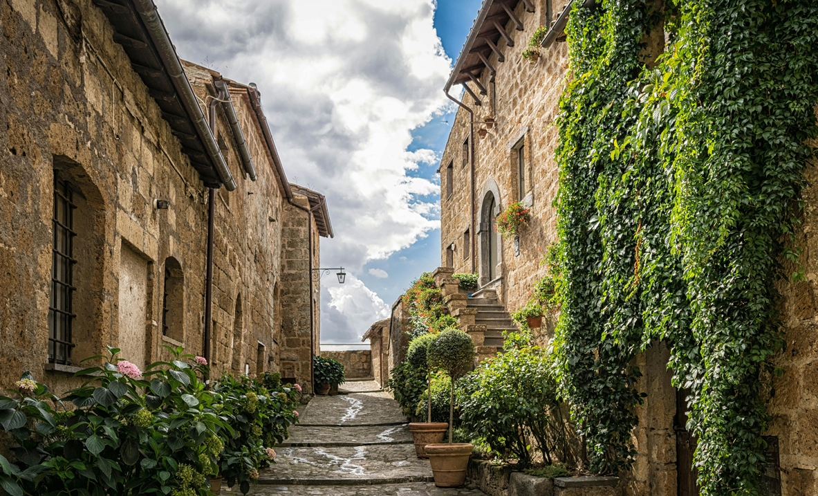 Charming Italian village street with stone buildings and greenery